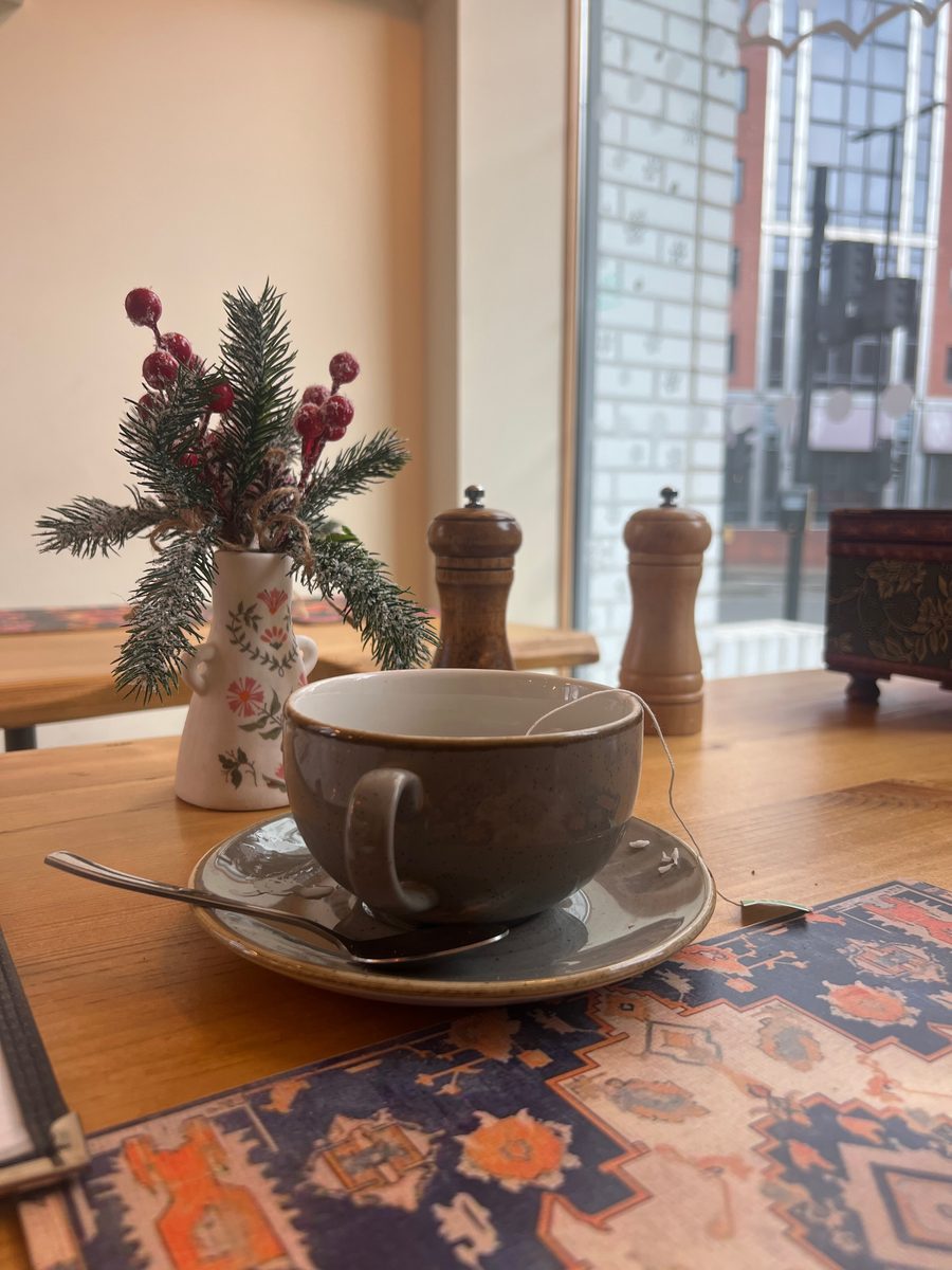 A cup of coffee on a patterned tiled table