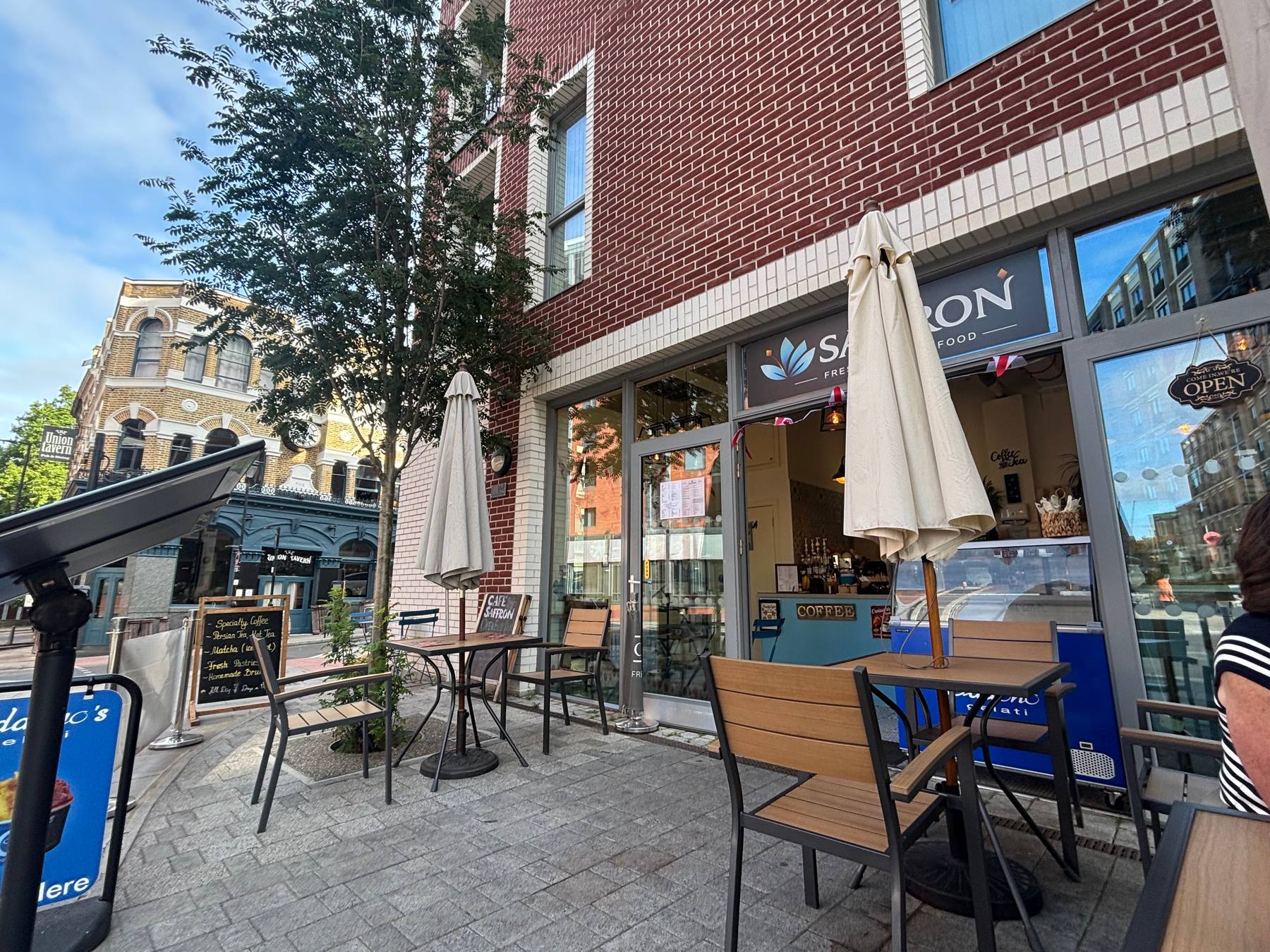 Café Saffron's terrace on Farringdon Road, with parasols and pavement tables